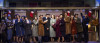 The song-and-dance duo Phil Davis (Evan C. Dolan, center, tan coat) and Bob Wallace (Alex Syiek, from left, black coat) meet cute on a crowded train ride to Vermont with sisters Betty Haynes (Sophie Grimm, light blue coat) and Judy Haynes (Jessie J. Potter, in purple) in Irving Berlin’s White Christmas.